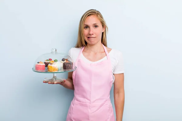 Blonde Young Adult Woman Looking Puzzled Confused Home Made Cakes — Foto de Stock