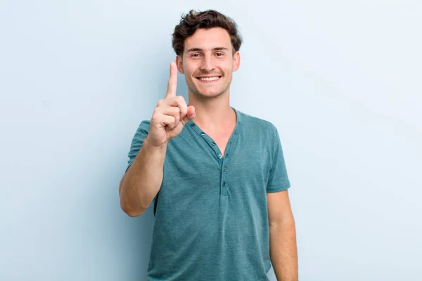 Young Handsome Man Smiling Proudly Confidently Making Number One Pose — Stock Photo, Image