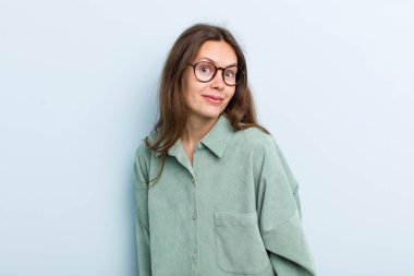 Genç, yetişkin, güzel bir kadın. Şapşal, çılgın, şaşırmış bir yüz ifadesi var. Yanakları şişmiş, doldurulmuş, şişman ve yemek dolu.