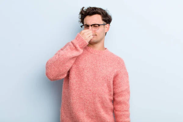 Young Handsome Man Feeling Disgusted Holding Nose Avoid Smelling Foul — Stock Photo, Image