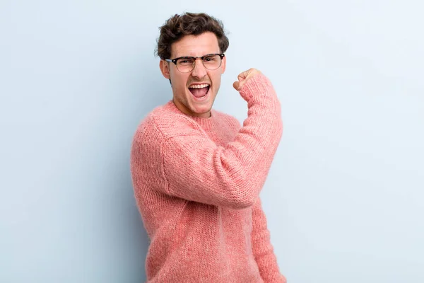 Young Handsome Man Feeling Happy Satisfied Powerful Flexing Fit Muscular — Stock Photo, Image