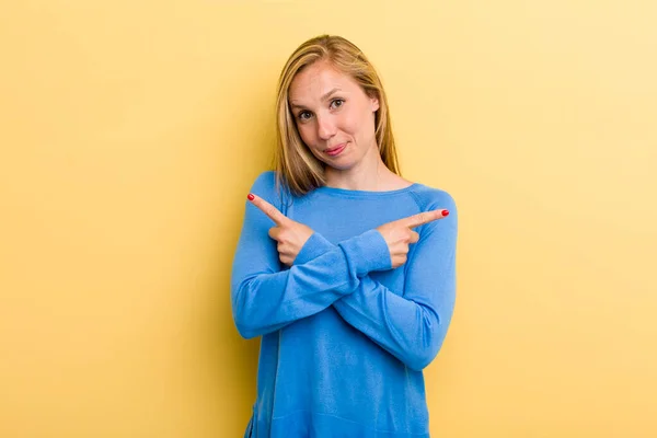 Young Adult Blonde Pretty Woman Looking Puzzled Confused Insecure Pointing — Foto Stock