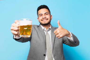 hispanic businessman happy expression and holding a beer