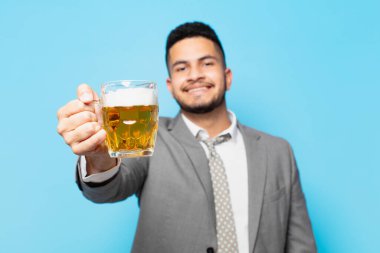 hispanic businessman happy expression and holding a beer