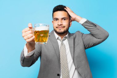 hispanic businessman scared expression and holding a beer