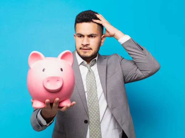 Hispanic Businessman Scared Expression Holding Piggy Bank — Zdjęcie stockowe