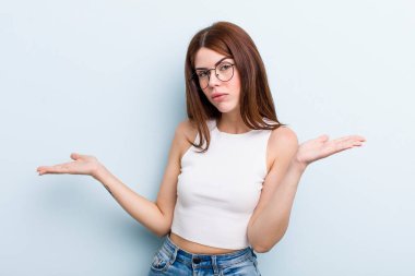 young adult pretty woman feeling puzzled and confused, unsure about the correct answer or decision, trying to make a choice