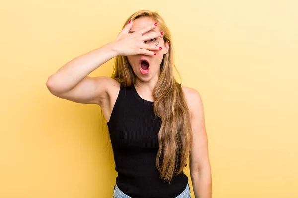 Young Adult Blonde Woman Looking Shocked Scared Terrified Covering Face — Stock fotografie