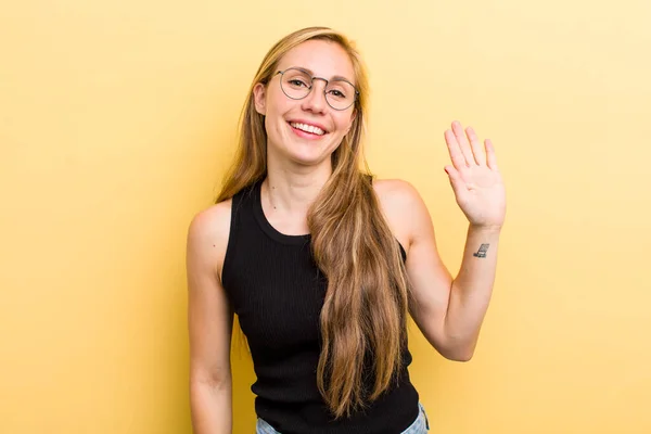 Young Adult Blonde Woman Smiling Happily Cheerfully Waving Hand Welcoming — Foto Stock