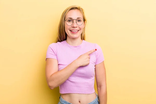 Young Adult Blonde Woman Smiling Cheerfully Feeling Happy Pointing Side — Foto Stock