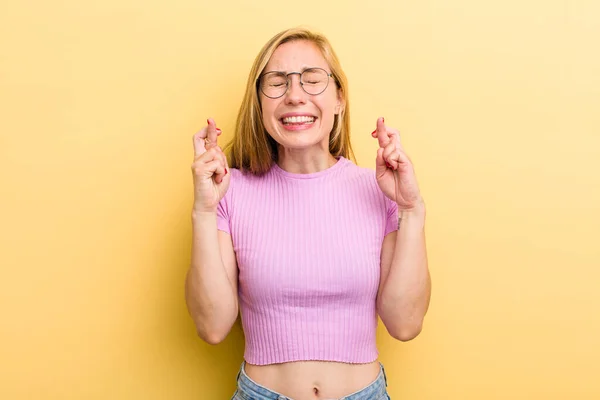 Young Adult Blonde Woman Smiling Anxiously Crossing Both Fingers Feeling — 图库照片