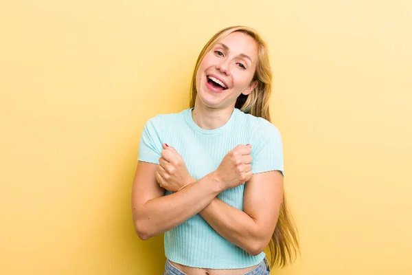 Young Adult Blonde Woman Smiling Cheerfully Celebrating Fists Clenched Arms — Stockfoto