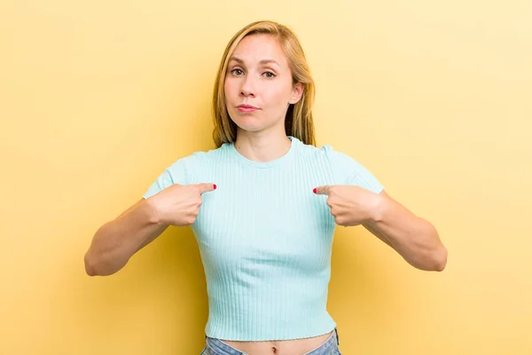 Young Adult Blonde Woman Pointing Self Confused Quizzical Look Shocked — ストック写真