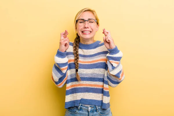 Young Adult Blonde Woman Crossing Fingers Anxiously Hoping Good Luck — Stockfoto