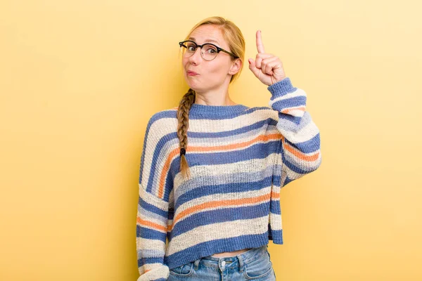 Young Adult Blonde Woman Feeling Genius Holding Finger Proudly Air — Stockfoto