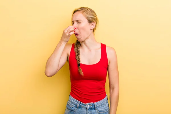 Young Adult Blonde Woman Feeling Disgusted Holding Nose Avoid Smelling — Stockfoto