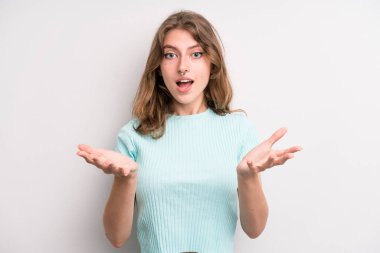 teenager young girl feeling extremely shocked and surprised, anxious and panicking, with a stressed and horrified look
