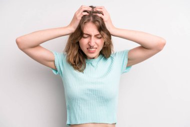 teenager young girl feeling stressed and frustrated, raising hands to head, feeling tired, unhappy and with migraine