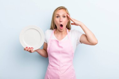 pretty blonde woman with an empty dish. chef concept
