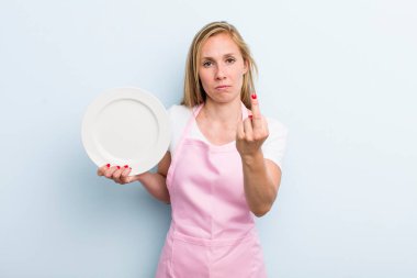 pretty blonde woman with an empty dish. chef concept