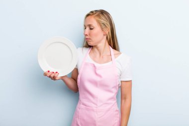 pretty blonde woman with an empty dish. chef concept
