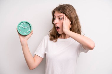 young girl holding an alarm clock. wake up concept