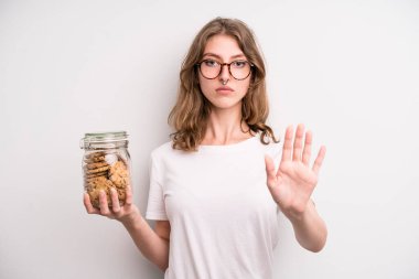 young girl holding home made cookies bottle