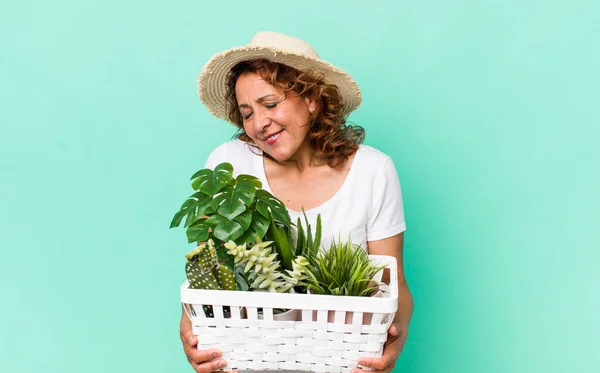 middle age pretty woman with plants. gardering concept