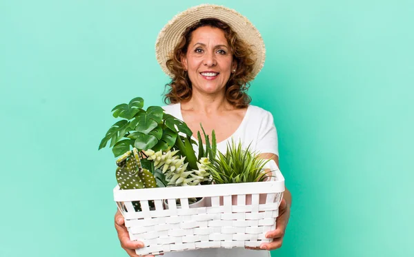 middle age pretty woman with plants. gardering concept