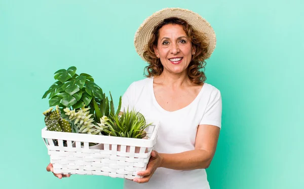 middle age pretty woman with plants. gardering concept