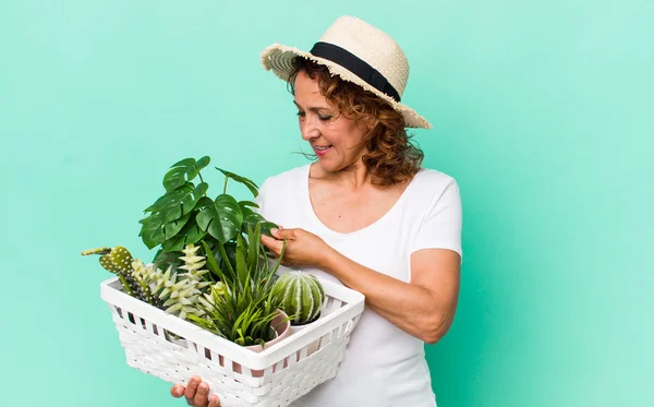 middle age pretty woman with plants. gardering concept