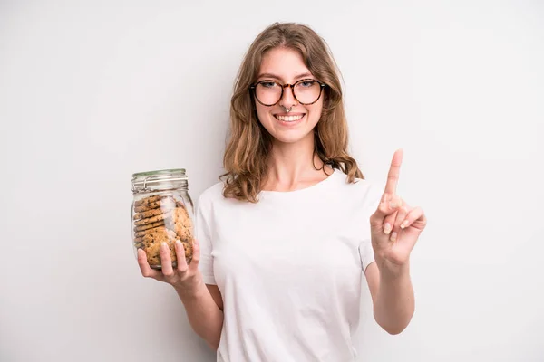 Young Girl Holding Home Made Cookies Bottle — Stockfoto