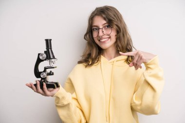 young girl scients student with a microscope