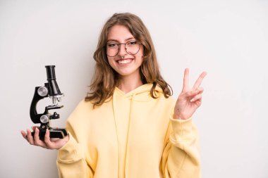 young girl scients student with a microscope
