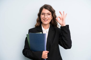 pretty young adult woman with notebooks. business concept