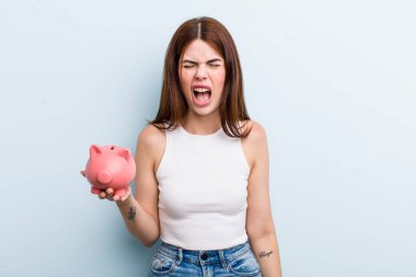 young adult pretty woman with a piggy bank