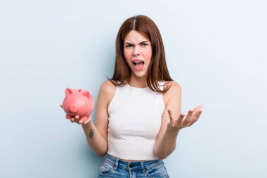 young adult pretty woman with a piggy bank