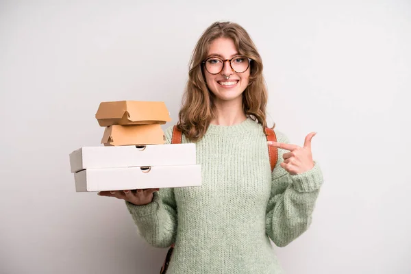 young girl with pizzas and burgers. take away fast food concept