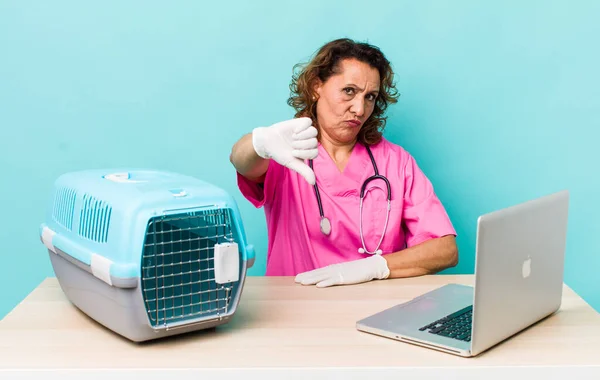 Middle Age Woman Feeling Cross Showing Thumbs Veterinarian Concept — Stockfoto