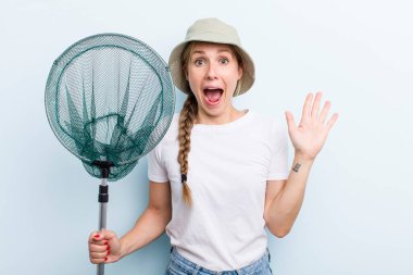 young adult blonde woman. fisher with a net and summer concept