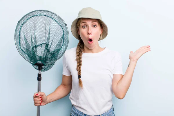 young adult blonde woman. fisher with a net and summer concept