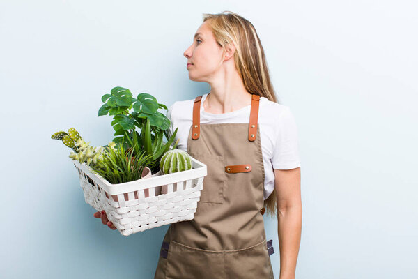 young adult blonde woman. farmer and gardering concept