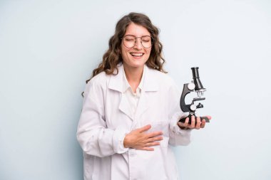 young adult pretty woman. scientist student with a microscope