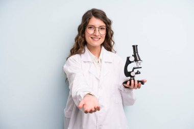 young adult pretty woman. scientist student with a microscope