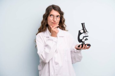 young adult pretty woman. scientist student with a microscope