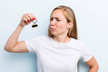 pretty blonde young adult woman with a car key