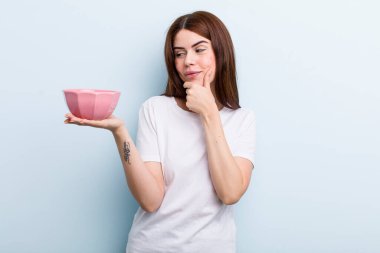 young adult pretty woman holding an empty bowl