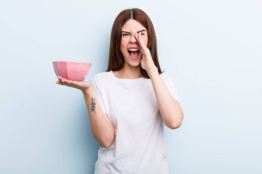 young adult pretty woman holding an empty bowl