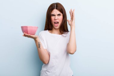 young adult pretty woman holding an empty bowl