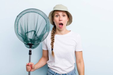 young adult blonde fisher woman with a net. holidays and hobbie concept
